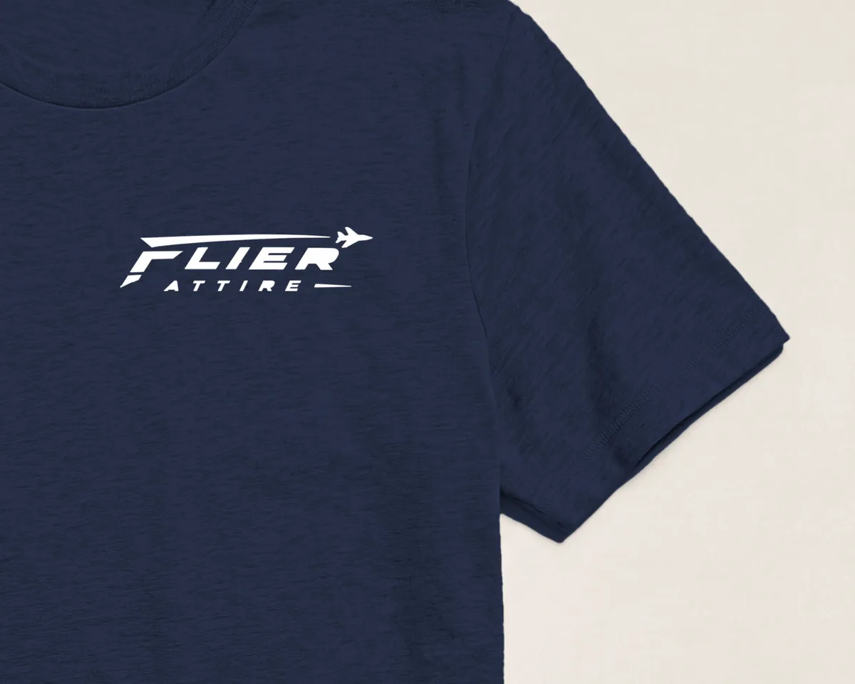 Flier Attire wordmark printed on the left chest, sleeve edge in frame