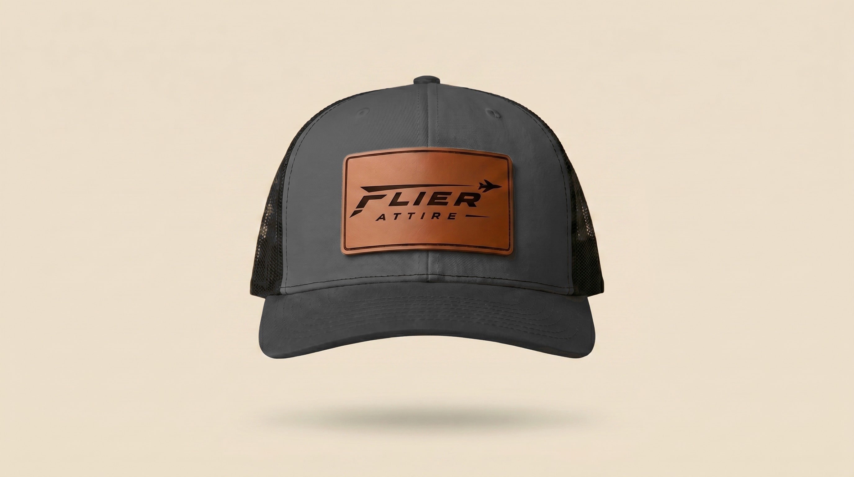 The Signature hat front view, grey panel with cognac leather wordmark patch
